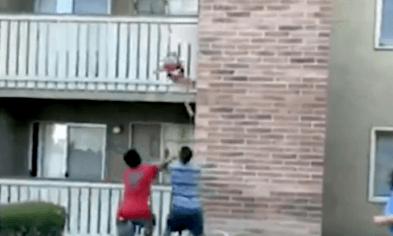 Ongelooflijk: man vangt kind dat uit brandend gebouw valt (video)