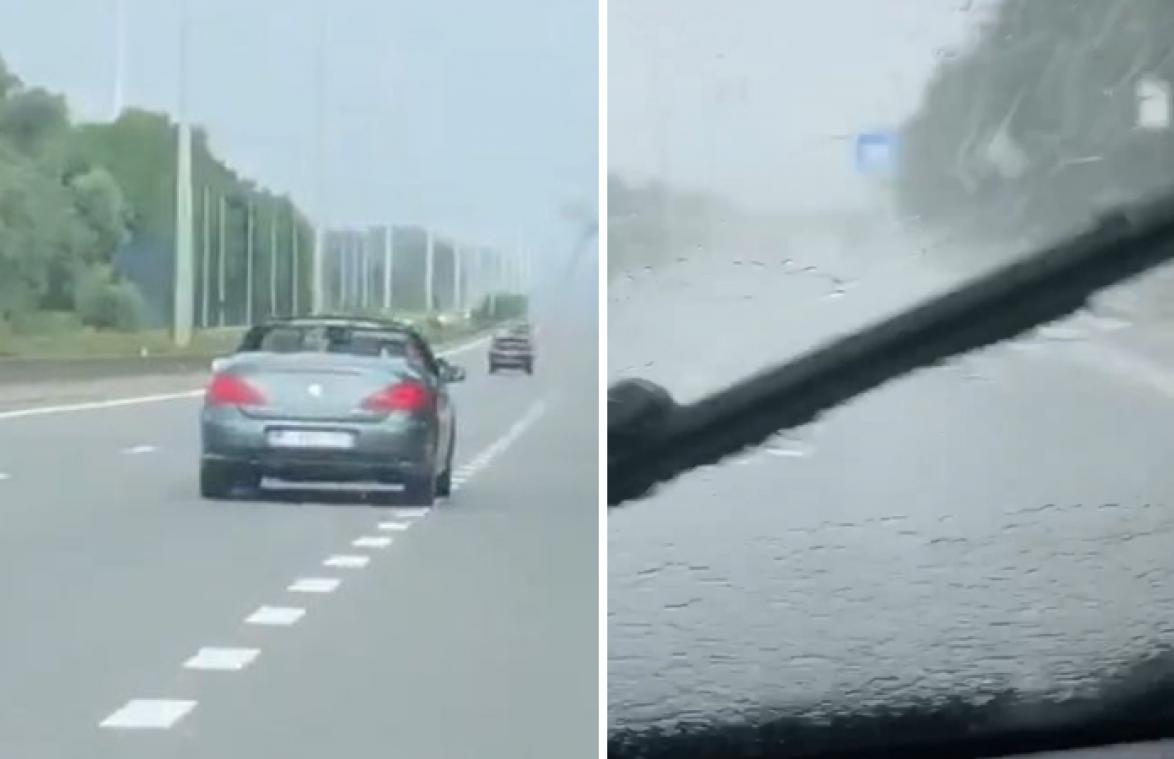 OOPS! Belgische bestuurder met open dak ziet stortbui te laat aankomen (video)