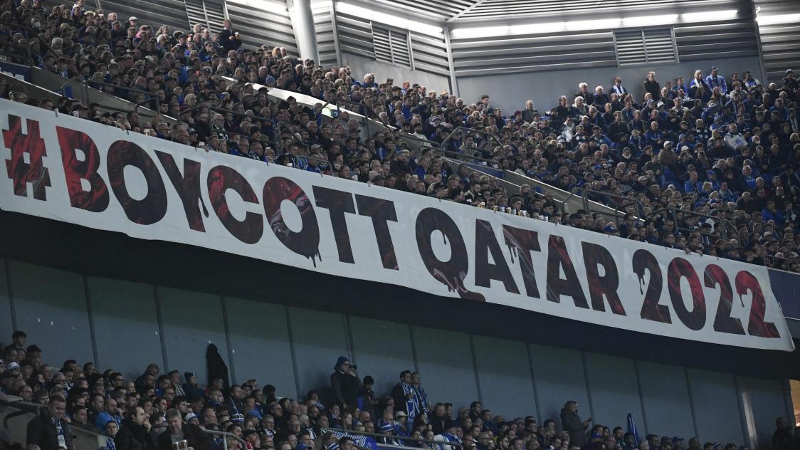 Football fans display a large banner reading 'Boykott Qatar' with reference to the 2022 FIFA Football World Cup to be played in Qatar, during the German first division Bundesliga football match between Schalke 04 v Bayern Munich in Gelsenkirchen, western Germany, on November 12, 2022. (Photo by UWE KRAFT / AFP) / DFL REGULATIONS PROHIBIT ANY USE OF PHOTOGRAPHS AS IMAGE SEQUENCES AND/OR QUASI-VIDEO