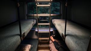 A Traveler is installed in a sleeper car of the Paris-Nice night train, between Paris and Nice, on May 20, 2021 on the day it returns to service after being stopped since December 2017. (Photo by Anne-Christine POUJOULAT / AFP)